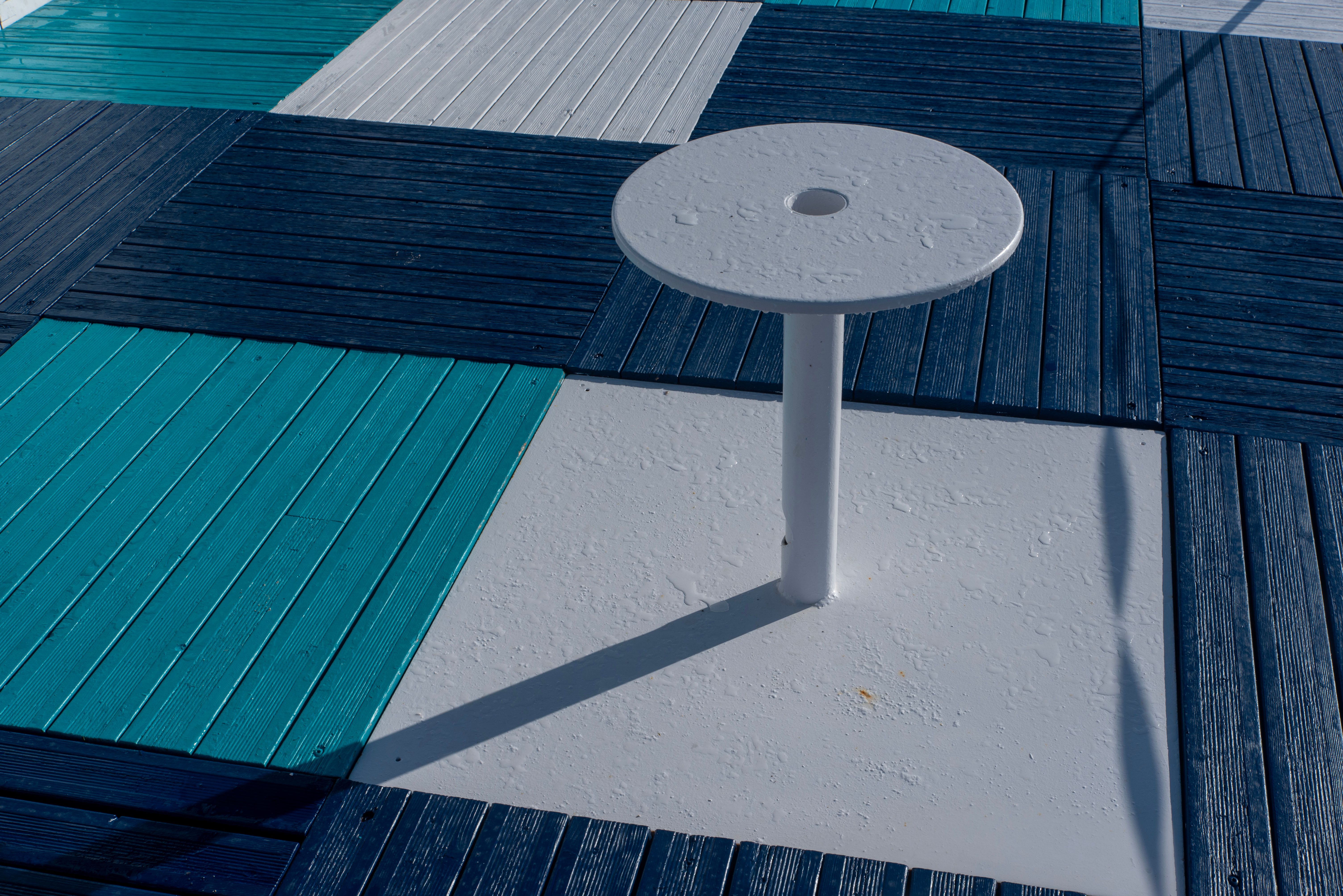 Colorful geometric deck boards creating a contemporary outdoor flooring pattern with strong shadows