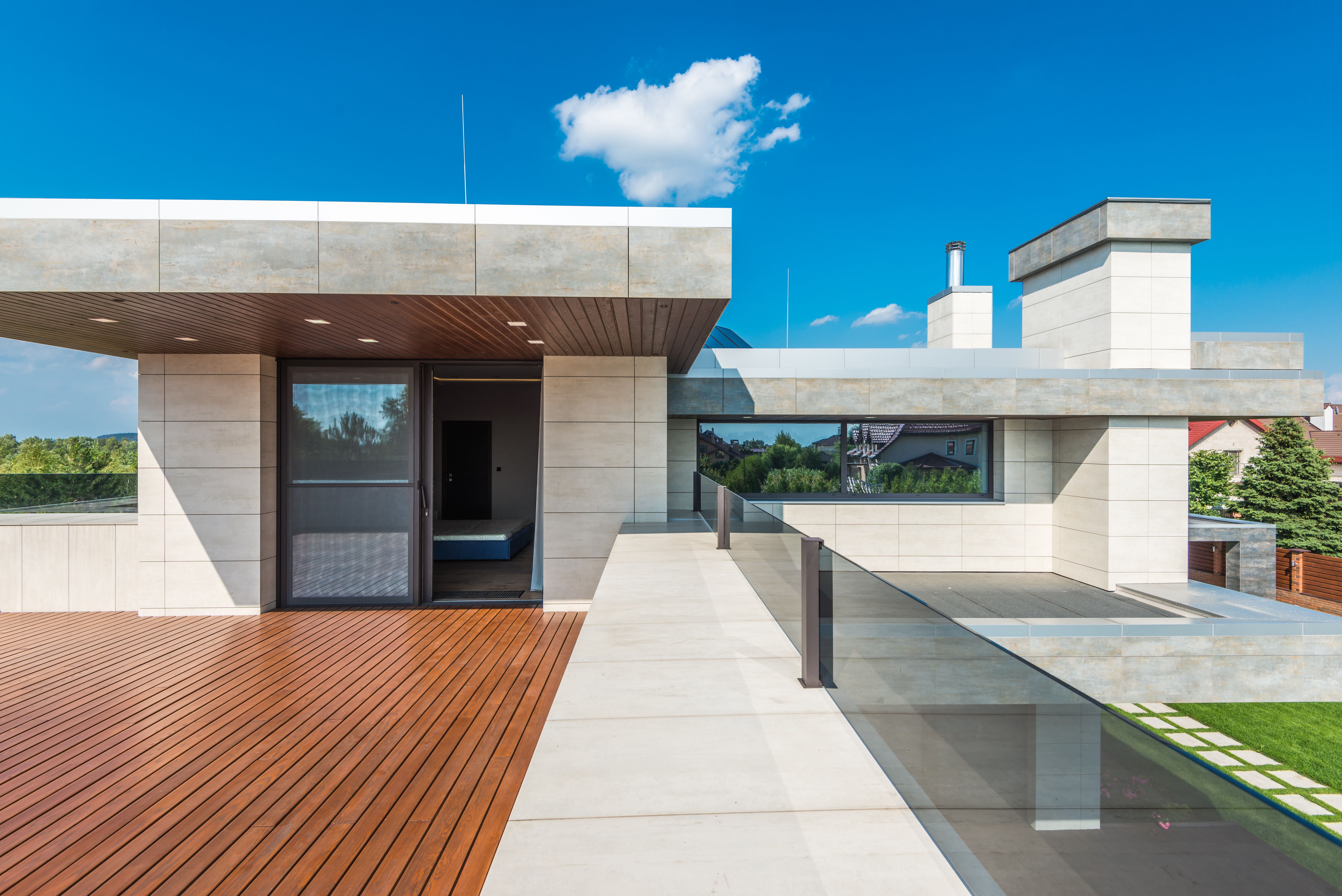 Sleek modern terrace with wood decking and clean architectural lines under a blue sky